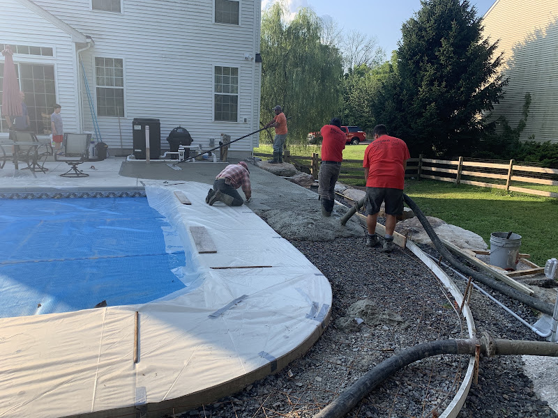 Inspire Contracting crew pouring a concrete pool deck