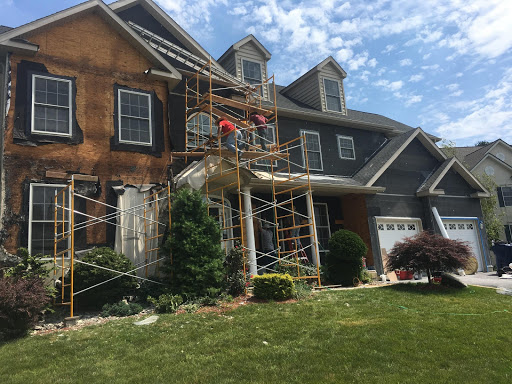 Stucco-to-siding conversion in progress by Inspire Contracting